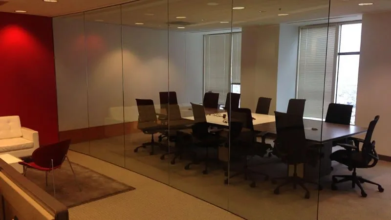 Clear glass partitions around a boardroom, before frosted film went on.