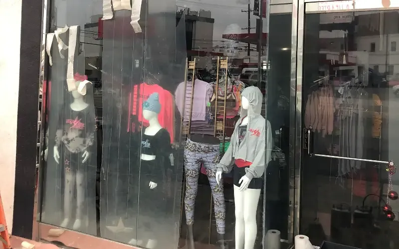 Scratched shopfront glazing obscuring the merchandise behind it.